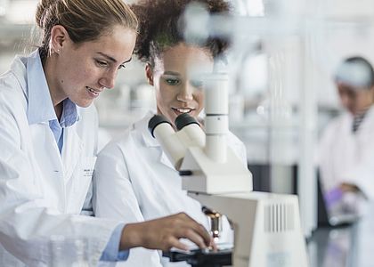 Image showing two scientists examiining a sample with a microscope