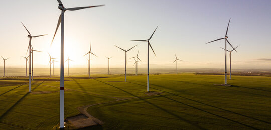 Image showing 17 turbines in a rural wind farm against the sunrise