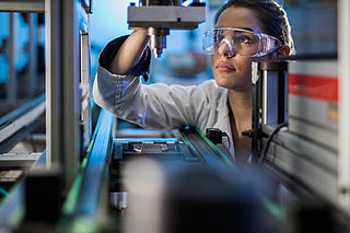 Image showing an Engineer examining machine part on a production line during performance testing