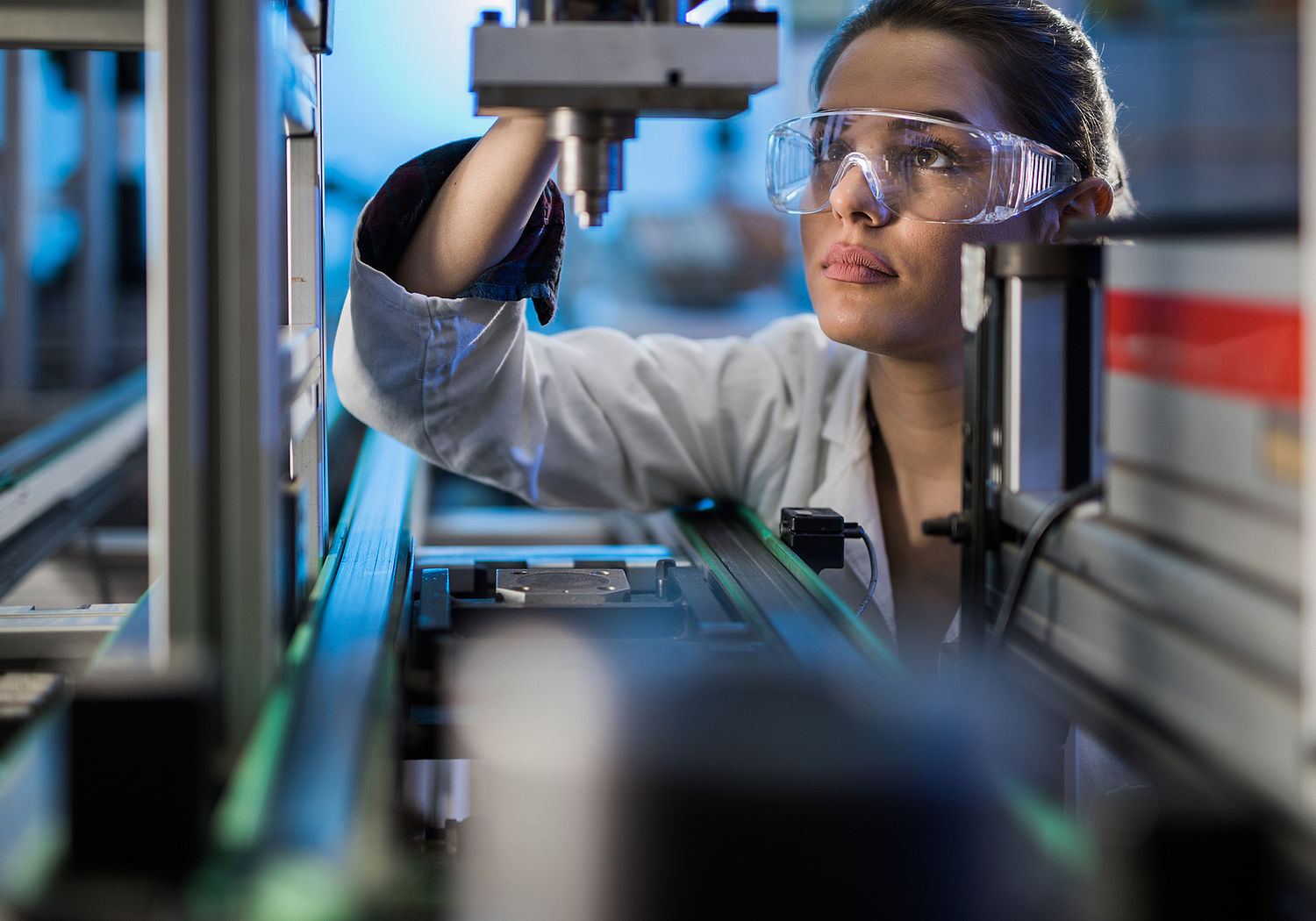 Image showing an Engineer examining machine part on a production line during performance testing