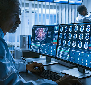 Image of a doctor examiing CT results on a computer screen