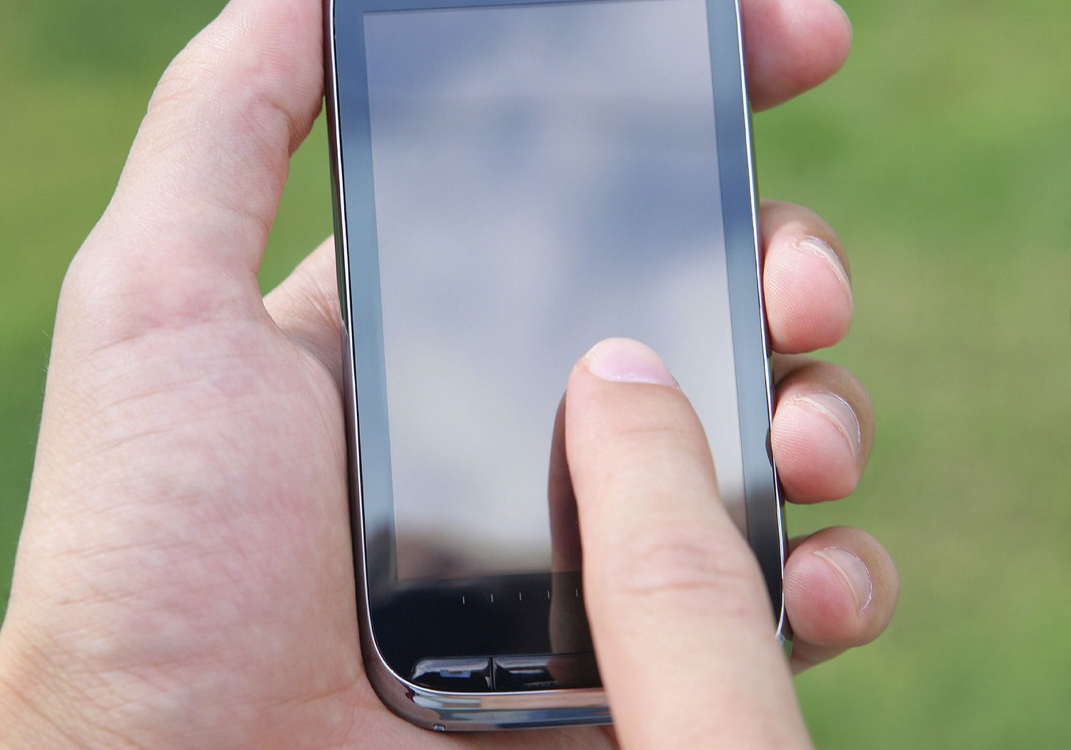 Image showing Hand and fingers touching a smart phone's screen