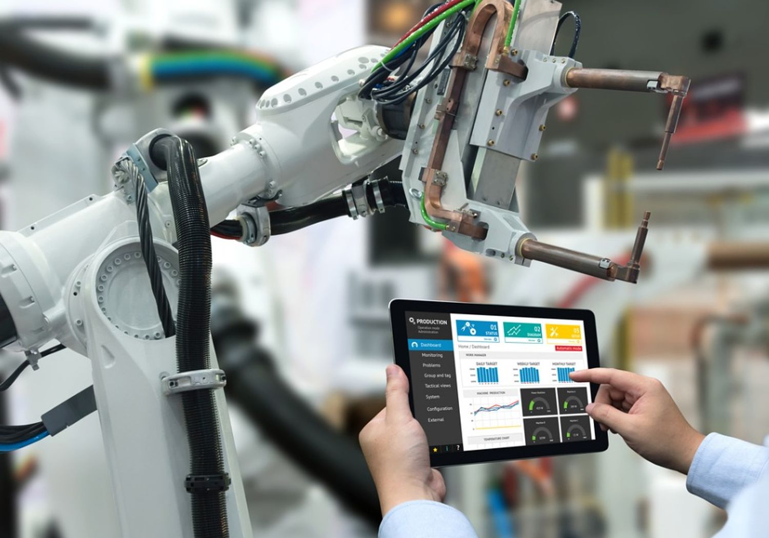 Image showing an Engineer controlling a robot arm in smart factory