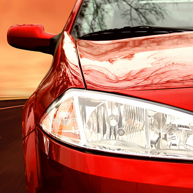 Image showing the right side of a red sportscar on a highway