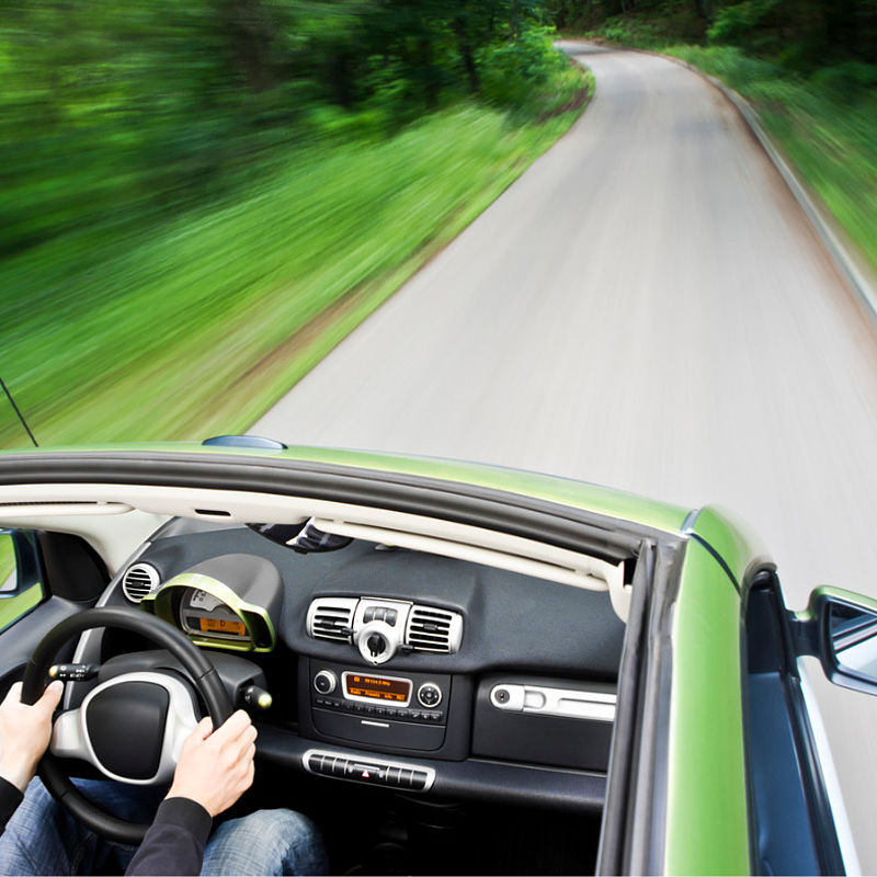 Image showing an electric car driving down an empty road