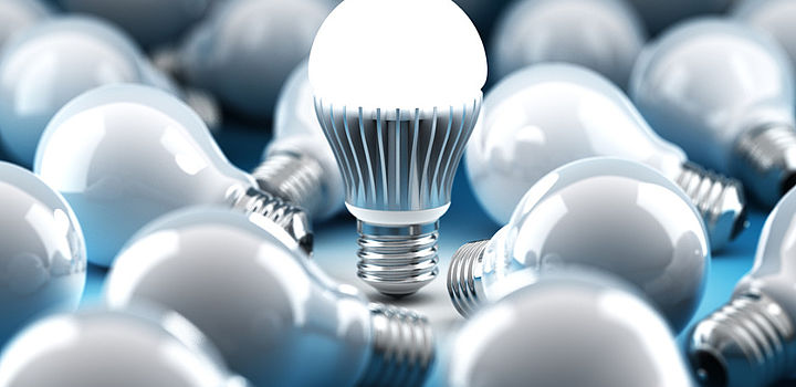 Image showing An LED bulb amongst old-style filament bulbs