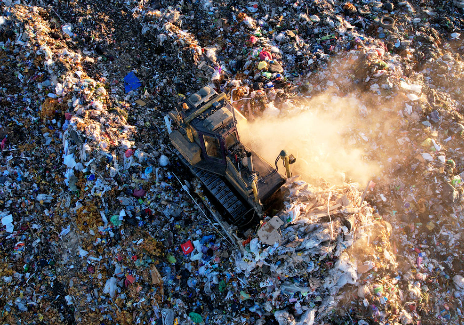 Image of a Bulldozer at landfill working on rubbish disposal