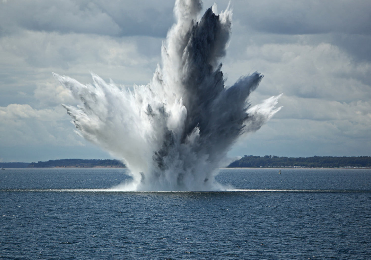 Image showing a huge water fountain caused by a below surface explosion