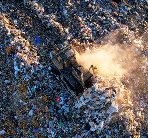 Image of a Bulldozer at landfill working on rubbish disposal