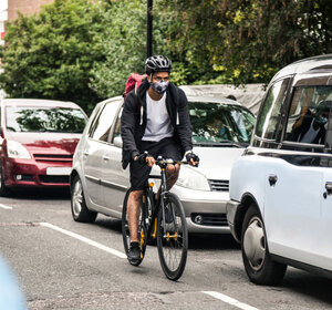 Cyclist commuter wearing a pollution mask