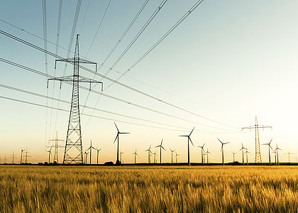 Power lines and wind turbines in autumn sunlight Image showing power lines and wind turbines in autumn sunlight