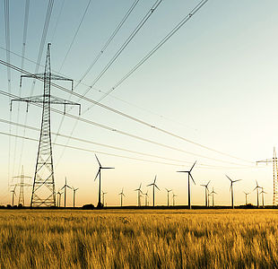 Power lines and wind turbines in autumn sunlight Image showing power lines and wind turbines in autumn sunlight
